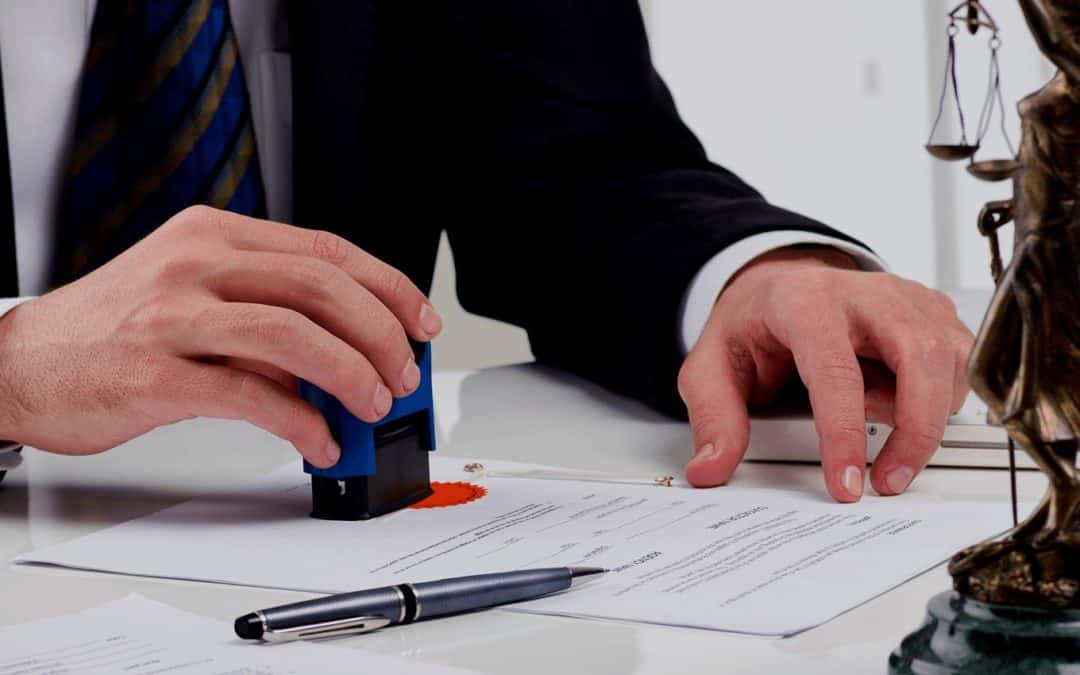 An attorney in San Diego is stamping a piece of paper.