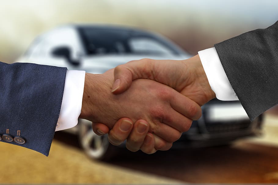 buying a new car from a dealership handshake