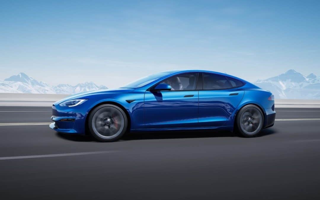 The blue Tesla Model S is driving down the road in California.