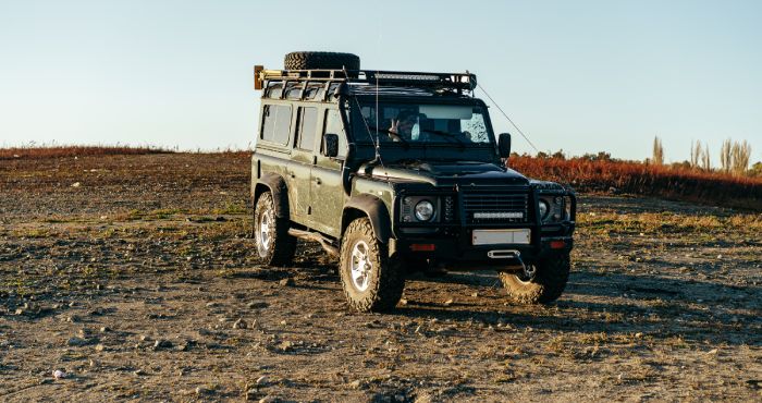 A black jeep parked on a dirt road in San Diego.