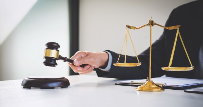 A lawyer's gavel on top of a desk.