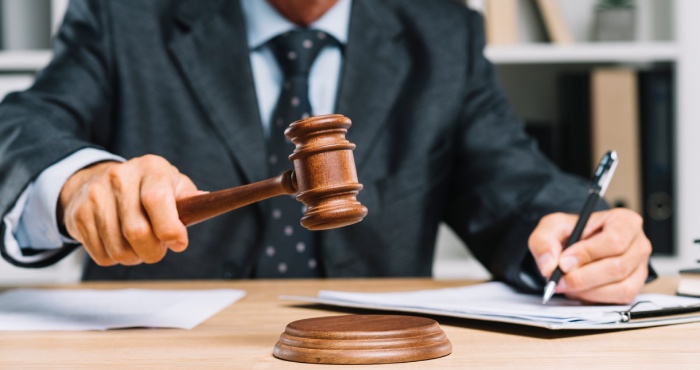 A San Diego lawyer specializing in lemon law cases, with a gavel on a laptop.