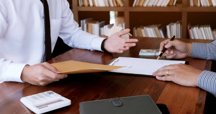 A California lemon law lawyer signing a document with a gavel.